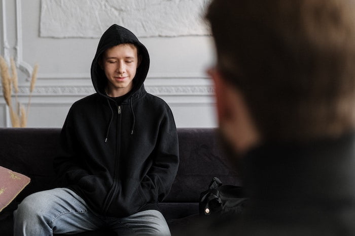 Teenager taking part in a session of addiction counselling